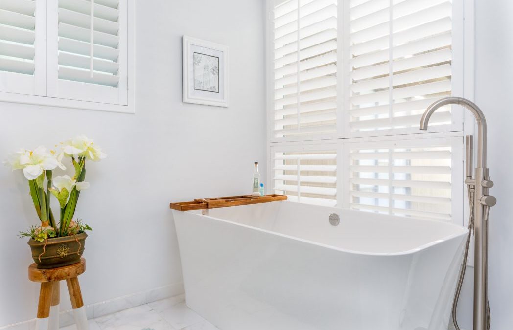 white on white bathroom, natural light, stand alone tub white prcelain, white wooden slat blinds - chris riggins construction photo