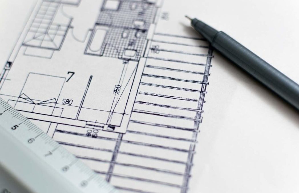 4 Myths About Design Build Projects, De-bunked! Blueprints and pen