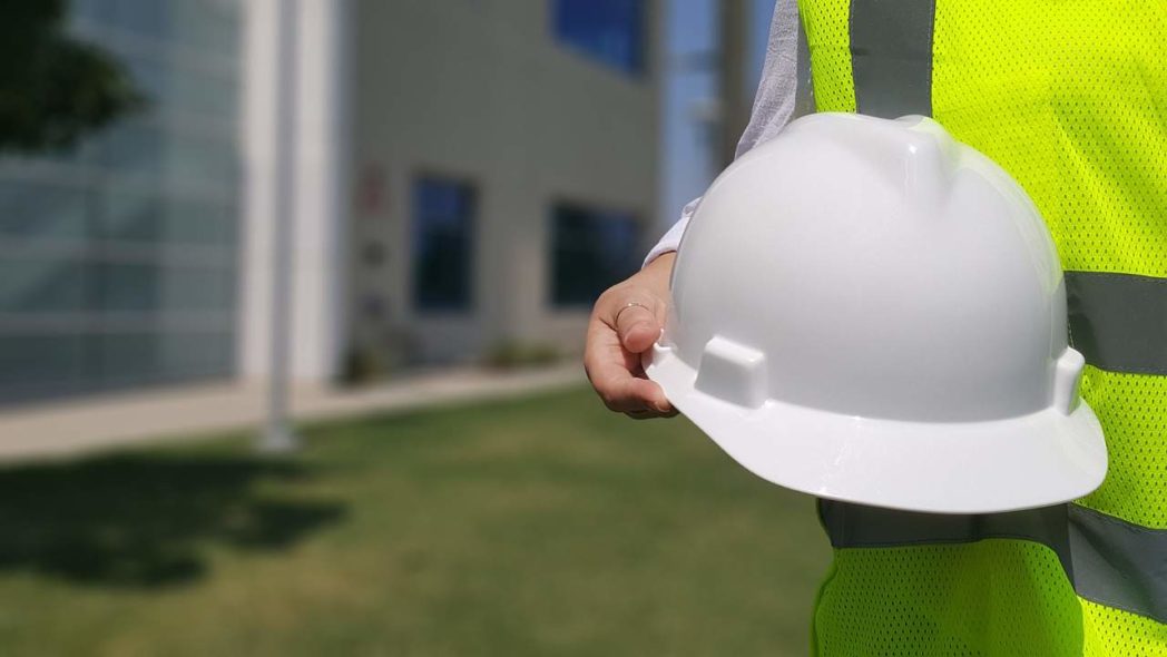 How to Choose a Design Build Contractor? - white hard hat in front of home